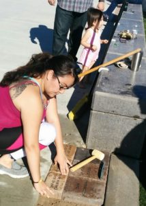 Photo of family member placing memorial brick